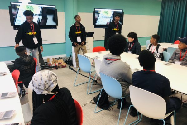 Hidden Genius Alumni Youth Educators lead a tech workshop to students of color from London.